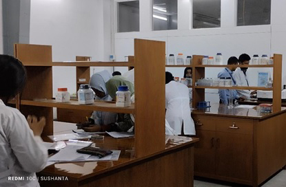 Pharmacy students working in modern pharmaceutical lab